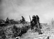 Marines movendo-se com o que foi posteriormente intitulada "Vale da Morte" por causa de mais de 125 mortes em 8 horas durante a travessia. Um homem com uma BAR cansado durante a travessia pelo vale da morte. Okinawa – 1945